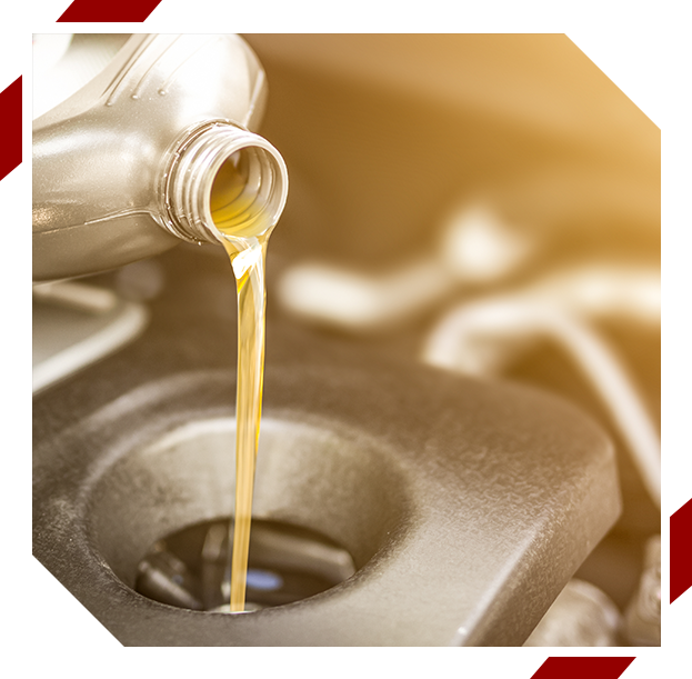 Pouring oil to car engine. Fresh oil poured during an oil change to a car